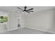Bright bedroom featuring soft carpeting, a ceiling fan and ensuite bathroom with a walk-in closet at 390 Windermere Dr, Lakeland, FL 33809