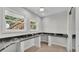 A home office is complete with natural light, a built-in desk and wood floors at 390 Windermere Dr, Lakeland, FL 33809