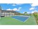 Backyard features a pickleball court with a screened pool enclosure in the background at 390 Windermere Dr, Lakeland, FL 33809