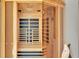 A close up view of a wooden sauna with a glass door at 390 Windermere Dr, Lakeland, FL 33809
