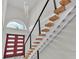 Modern staircase with wood treads, black railings, and abundant natural light at 390 Windermere Dr, Lakeland, FL 33809