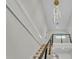 Modern staircase with wood treads, black metal railings, and a striking contemporary chandelier at 390 Windermere Dr, Lakeland, FL 33809