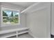 Well-lit walk-in closet with a window and white shelving at 390 Windermere Dr, Lakeland, FL 33809