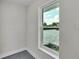 Interior window view overlooking the backyard featuring stone pavers and a green hedge at 390 Windermere Dr, Lakeland, FL 33809