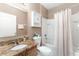 Bathroom with tiled vanity countertop, single sink, toilet, and bathtub/shower combo at 6898 Glenbrook Dr, Lakeland, FL 33811