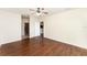 Spacious bedroom with wood-look flooring, a ceiling fan, and an open doorway to another room at 6898 Glenbrook Dr, Lakeland, FL 33811