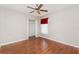 Bedroom with wood-look flooring, a closet, a window with shade, and a ceiling fan with light fixture at 6898 Glenbrook Dr, Lakeland, FL 33811