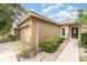 Side view showing garage, walkway, and well maintained hedges at 6898 Glenbrook Dr, Lakeland, FL 33811