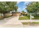 Inviting single-story home with a well-kept lawn, a two-car garage, and appealing curb appeal at 6898 Glenbrook Dr, Lakeland, FL 33811