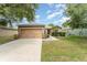 Charming single-story home features a well-maintained lawn, a two-car garage, and beautiful landscaping at 6898 Glenbrook Dr, Lakeland, FL 33811