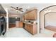 Kitchen featuring white tile floors, granite countertops and wooden cabinets at 6898 Glenbrook Dr, Lakeland, FL 33811