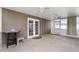 Enclosed sunroom featuring double doors, dual ceiling fans, and bright natural light at 6898 Glenbrook Dr, Lakeland, FL 33811