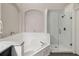 Bright bathroom features a soaking tub and a separate glass enclosed shower at 8360 Lake Amhurst Trl, Orlando, FL 32829