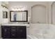 Bathroom with dual sinks, granite counters and a soaking tub with tile surround at 8360 Lake Amhurst Trl, Orlando, FL 32829
