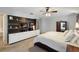 Bedroom featuring a modern entertainment center with white cabinets and ceiling fan at 8360 Lake Amhurst Trl, Orlando, FL 32829