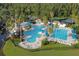 Aerial view of a large community pool and kiddie pool featuring a waterslide, lounging area, and lush landscaping at 8360 Lake Amhurst Trl, Orlando, FL 32829