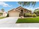 Charming single-story home with a well-maintained lawn and two-car garage at 8360 Lake Amhurst Trl, Orlando, FL 32829
