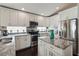 Modern kitchen with white cabinetry, stainless steel appliances, and granite countertops at 8360 Lake Amhurst Trl, Orlando, FL 32829