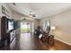 Spacious living room area featuring hardwood floors and access to outdoor space at 8360 Lake Amhurst Trl, Orlando, FL 32829