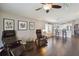 Open living room and kitchen space with hardwood floors and comfortable seating at 8360 Lake Amhurst Trl, Orlando, FL 32829