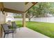 Covered patio with chairs overlooking a spacious, fenced backyard at 8360 Lake Amhurst Trl, Orlando, FL 32829