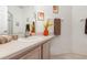 Well-lit bathroom featuring a single sink vanity, neutral color palette, decorative accents, and essential amenities at 908 Andalusia Loop, Davenport, FL 33837