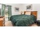 Comfortable bedroom featuring a wooden headboard, side table, soft lighting, and natural light from the window at 908 Andalusia Loop, Davenport, FL 33837