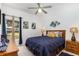 Cozy bedroom featuring a ceiling fan, wood furnishings, decorative artwork, and warm natural light at 908 Andalusia Loop, Davenport, FL 33837