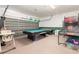 Spacious garage featuring a pool table, air hockey table, and recreational amenities for indoor fun at 908 Andalusia Loop, Davenport, FL 33837