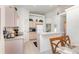 Bright kitchen and dining area with ample cabinet space and appliances, with access to the laundry room at 908 Andalusia Loop, Davenport, FL 33837