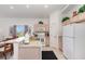 Bright kitchen and dining area with ample cabinet space and appliances, plus a view of the outdoors at 908 Andalusia Loop, Davenport, FL 33837