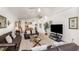 Cozy living room featuring vaulted ceilings, comfortable leather sofas, glass tables, and an entertainment center at 908 Andalusia Loop, Davenport, FL 33837