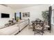 Bright living room and dining area with modern furniture, stylish decor, and a view of the outdoors at 908 Andalusia Loop, Davenport, FL 33837