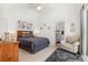 Bright main bedroom featuring vaulted ceilings, an ensuite bathroom, comfortable furnishings, and a sliding glass door at 908 Andalusia Loop, Davenport, FL 33837