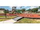 Community playground featuring multiple play structures, slides, and a soft, safe ground cover at 908 Andalusia Loop, Davenport, FL 33837