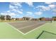 Community tennis court available for residents, with neighborhood clubhouse and playground in the background at 908 Andalusia Loop, Davenport, FL 33837