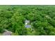 Overhead view of a property nestled amongst trees featuring a screened porch and long driveway at 9530 Sw 189Th Ct, Dunnellon, FL 34432