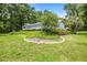 Expansive backyard with healthy green grass, mature trees, and a screened-in porch at 9530 Sw 189Th Ct, Dunnellon, FL 34432