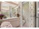 Bathroom featuring a vanity, mirror, decorative wallpaper, and adjacent toilet at 9530 Sw 189Th Ct, Dunnellon, FL 34432