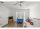 Bright bedroom with a ceiling fan and wood flooring at 9530 Sw 189Th Ct, Dunnellon, FL 34432