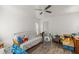 Bright bedroom with a ceiling fan, wood flooring, and natural light at 9530 Sw 189Th Ct, Dunnellon, FL 34432