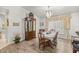 Formal dining room featuring a chandelier, wood floors, and display cabinet at 9530 Sw 189Th Ct, Dunnellon, FL 34432