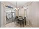 Charming dining area featuring a chandelier, sliding glass doors, and decorative wallpaper at 9530 Sw 189Th Ct, Dunnellon, FL 34432