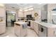 Bright kitchen featuring lots of cabinet space, a central island, and a view to the dining room at 9530 Sw 189Th Ct, Dunnellon, FL 34432