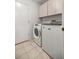 Functional laundry room with tile flooring and modern washer and dryer units at 9530 Sw 189Th Ct, Dunnellon, FL 34432