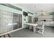 Outdoor patio with dining area, kitchen setup, and sliding door access to the pool at 9530 Sw 189Th Ct, Dunnellon, FL 34432
