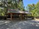 Open wooden pavilion with picnic tables, perfect for outdoor gatherings and community events at 9530 Sw 189Th Ct, Dunnellon, FL 34432