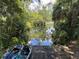 Beautiful water view with kayaks, showcasing easy water access amidst lush greenery and serene nature at 9530 Sw 189Th Ct, Dunnellon, FL 34432