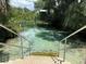 Scenic water view with clear waters, featuring stairs for easy access and lush green foliage at 9530 Sw 189Th Ct, Dunnellon, FL 34432