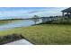 Backyard with pond view, black metal fence, and lush green grass at 3974 Mekong Ct, St Cloud, FL 34772